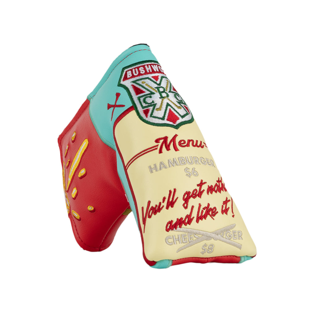 A novelty golf club headcover designed to look like a Caddyshack Halfway House menu, featuring a red side with yellow menu, a cream-colored front with red script text, and a turquoise top section with a Bushwood logo.