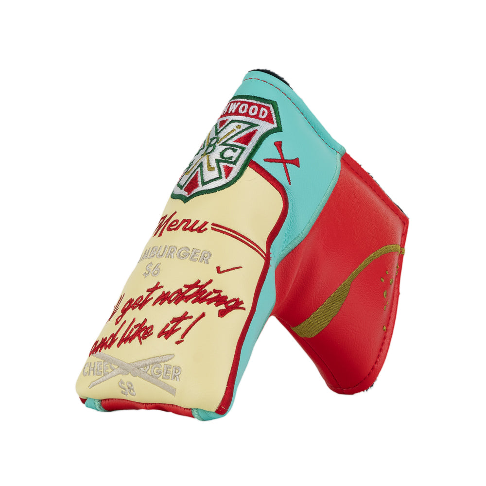 A novelty golf club headcover designed to look like a Caddyshack Halfway House menu, featuring a red side with yellow menu, a cream-colored front with red script text, and a turquoise top section with a Bushwood logo.