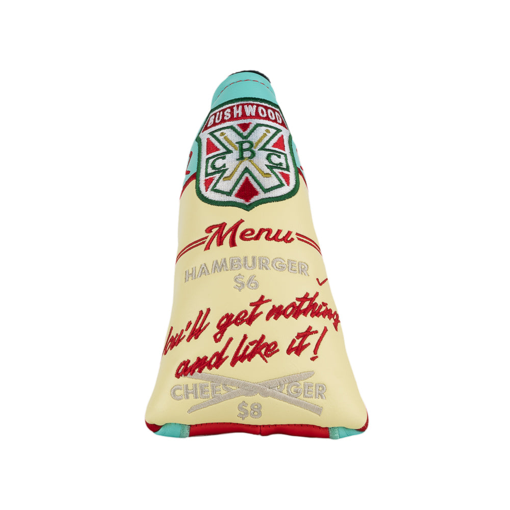 A novelty golf club headcover designed to look like a Caddyshack Halfway House menu, featuring a red side with yellow menu, a cream-colored front with red script text, and a turquoise top section with a Bushwood logo.