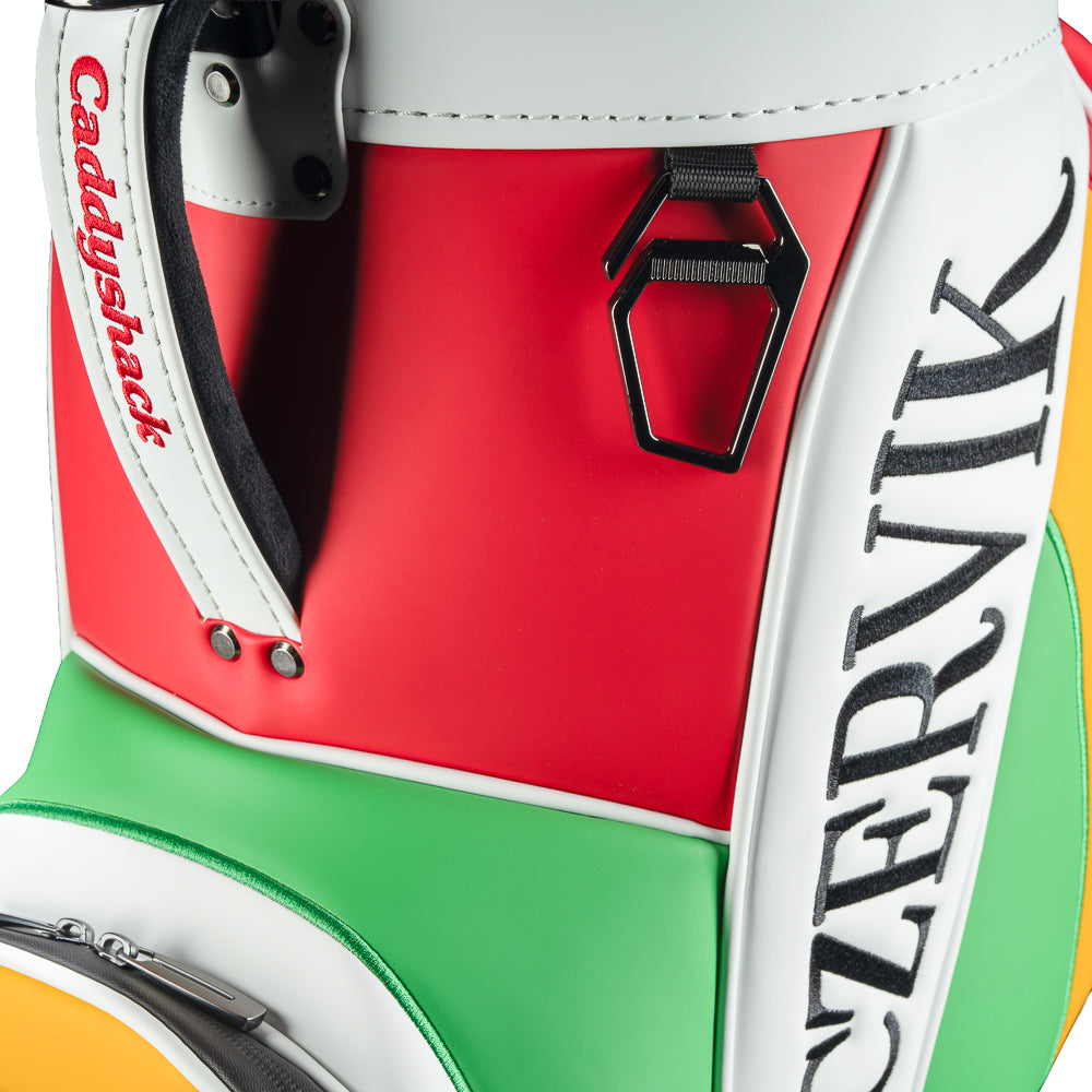 Rewind Golf Caddyshack Czervik Den Caddy Cooler with red, white, green, and yellow panels, vertical Czervik lettering, and a red zippered pocket with a Bushwood crest.