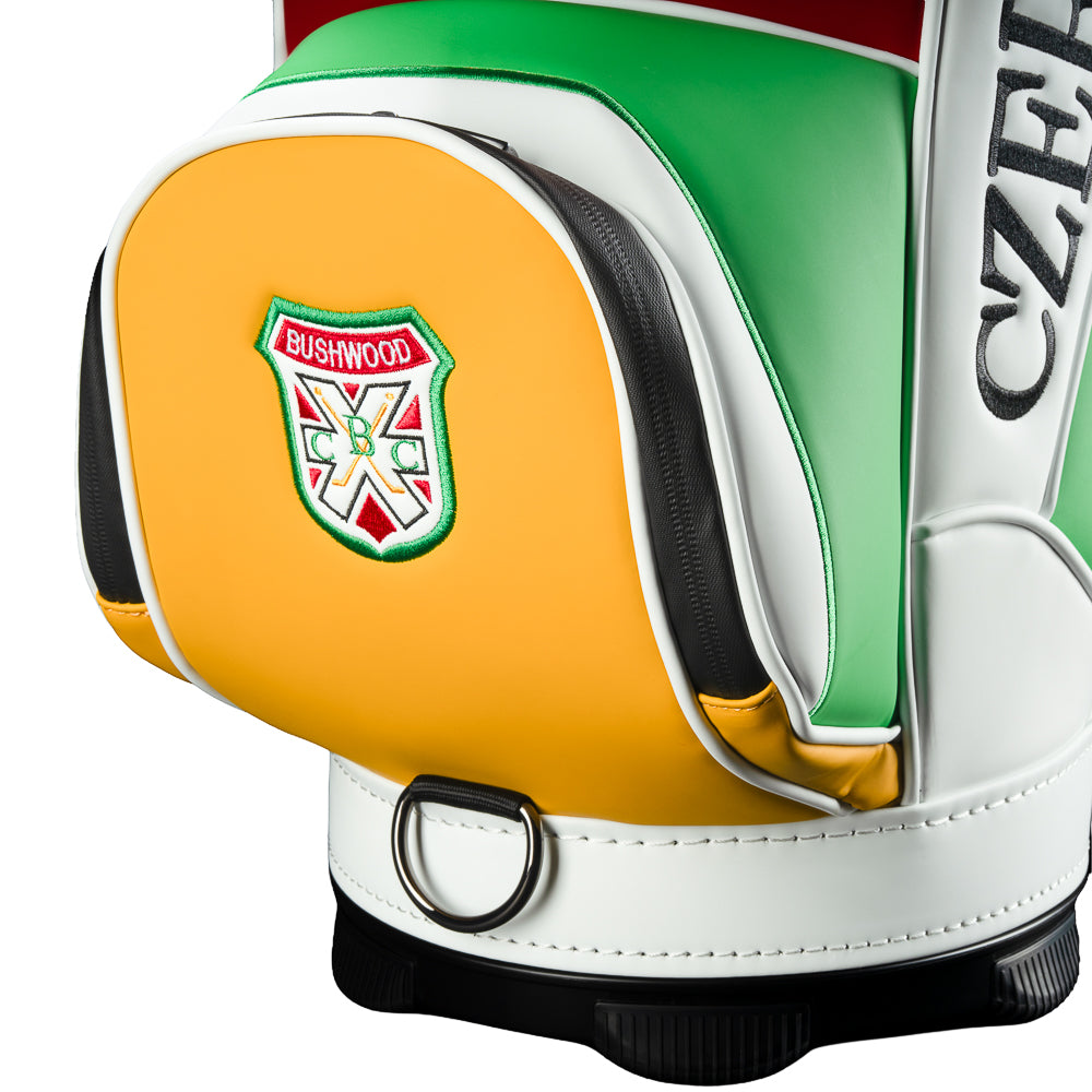 Rewind Golf Caddyshack Czervik Den Caddy Cooler with red, white, green, and yellow panels, vertical Czervik lettering, and a red zippered pocket with a Bushwood crest.