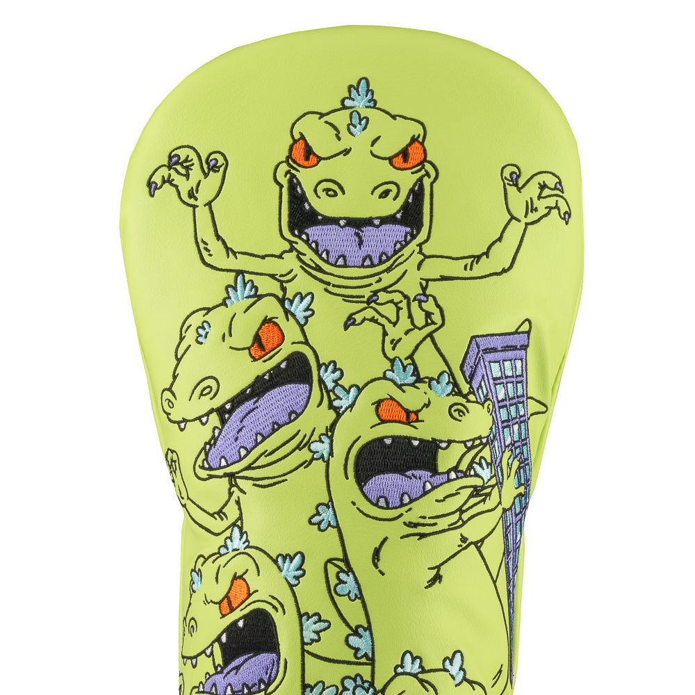 Green Rugrats Reptar driver cover with stacked cartoon Reptar design holding a building, bold Rewind Golf headcover style.