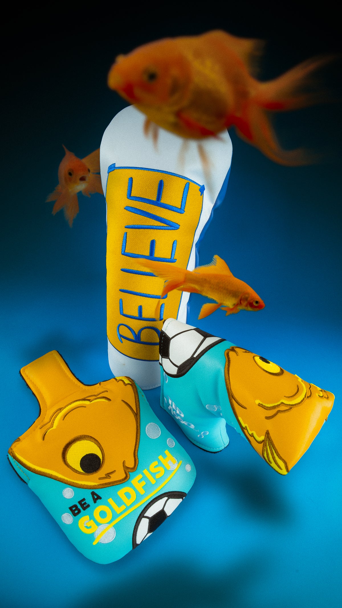 Rewind Golf x Ted Lasso official tv show themed golf headcovers featuring 'BELIEVE' and Be A Goldfish designs on blue background.